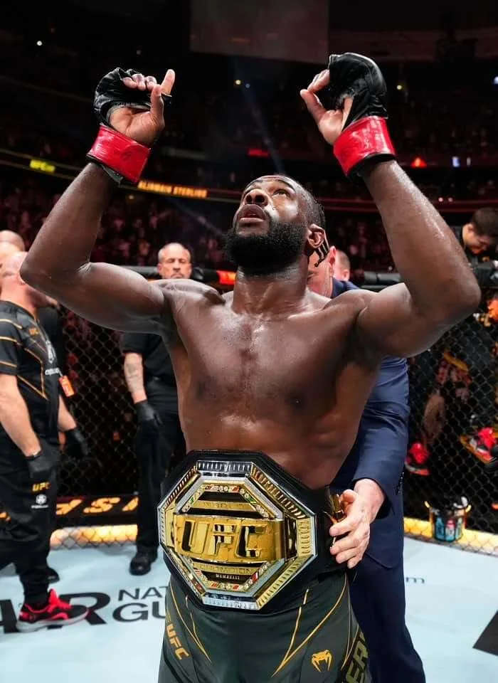 Aljamain Sterling celebrating under arena lights